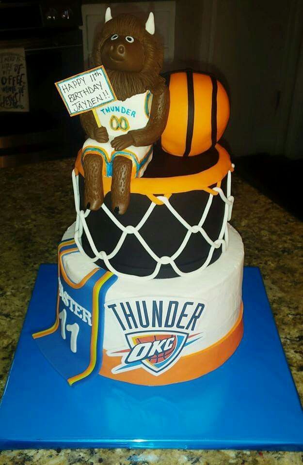 a birthday cake with a hockey themed bear holding a sign that says thunder on it