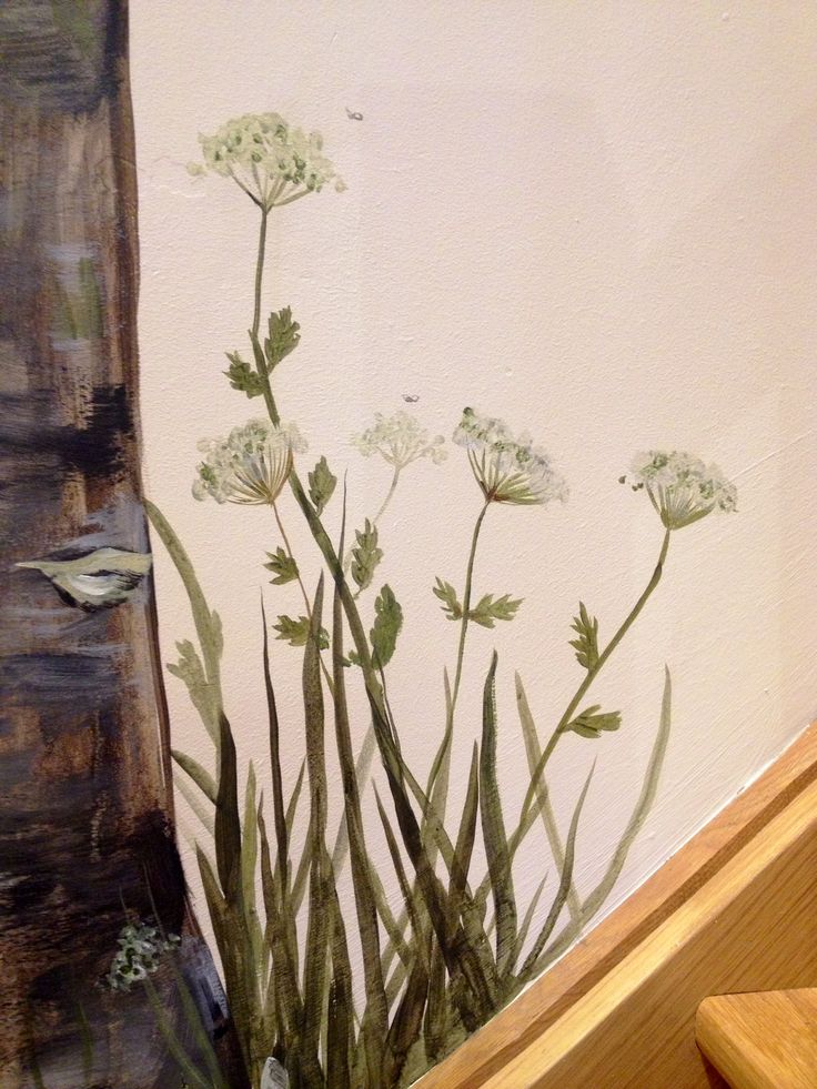 a painting of flowers on the side of a wall