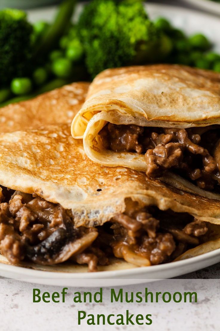 beef and mushroom pancakes on a white plate with broccoli in the back ground