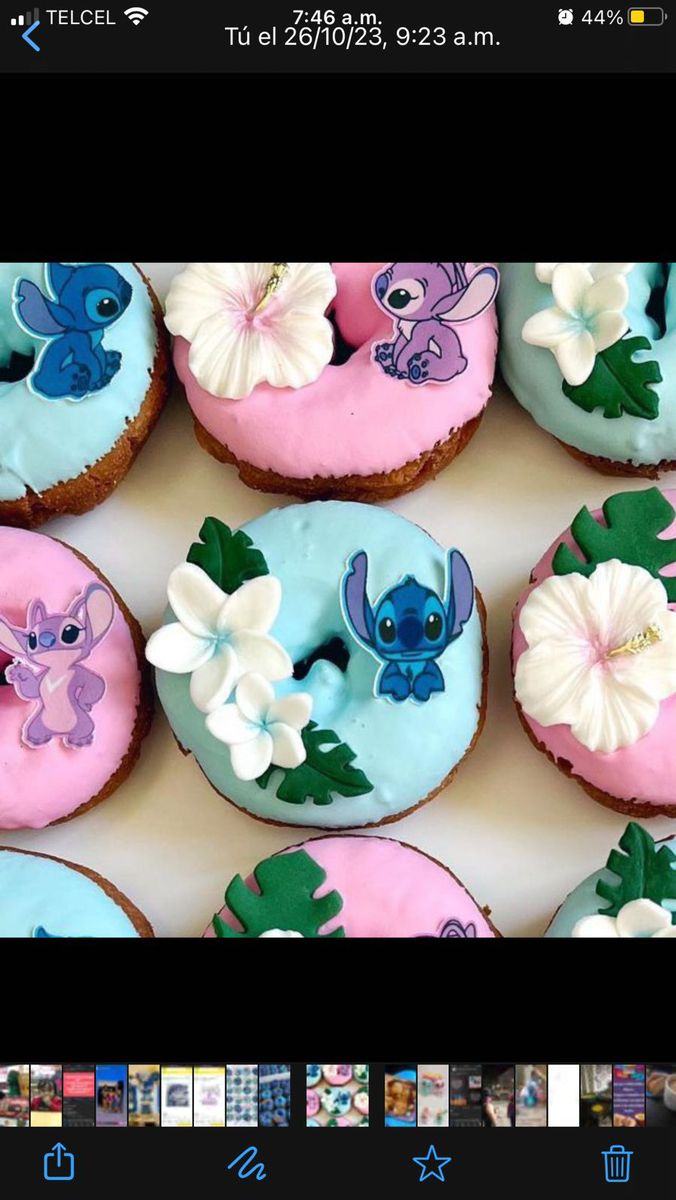 there are many decorated doughnuts on the table with flowers and leaves painted on them