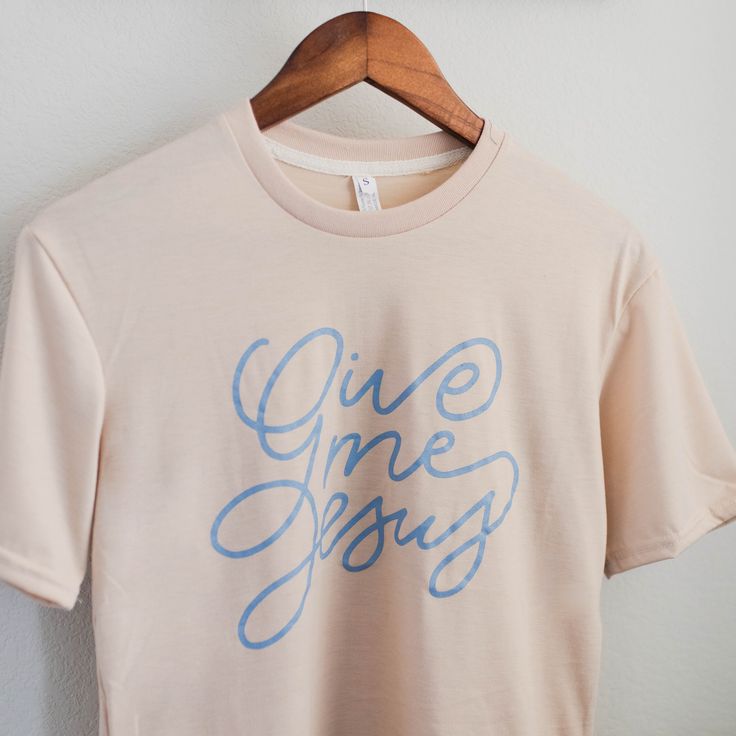 Infuse your faith into your everyday style with our Give Me Jesus Tee. Made from an extremely soft polyester-spandex blend, this cream shirt features a beautiful script design by the Daily Grace Co. team. Inspired by a beloved hymn, it's a great reminder to keep your focus on Jesus. Want to know if this will fit? Check our sizing chart! Bible Verse Shirt Design, Church Merch Ideas, Trendy Tshirt Designs, Cricut Shirt Ideas, Jesus Shirts Women, Jesus Merch, Church Merch, Daily Grace Co, Women Tshirt Design