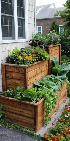 three wooden planters filled with plants next to a house