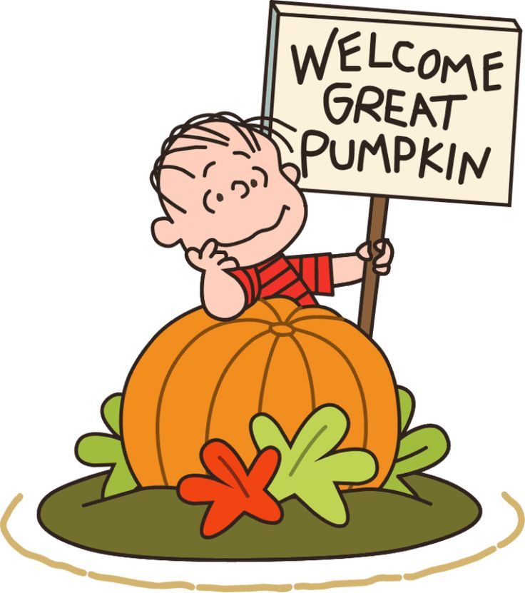 a little boy holding a sign that says welcome great pumpkin on top of a giant pumpkin