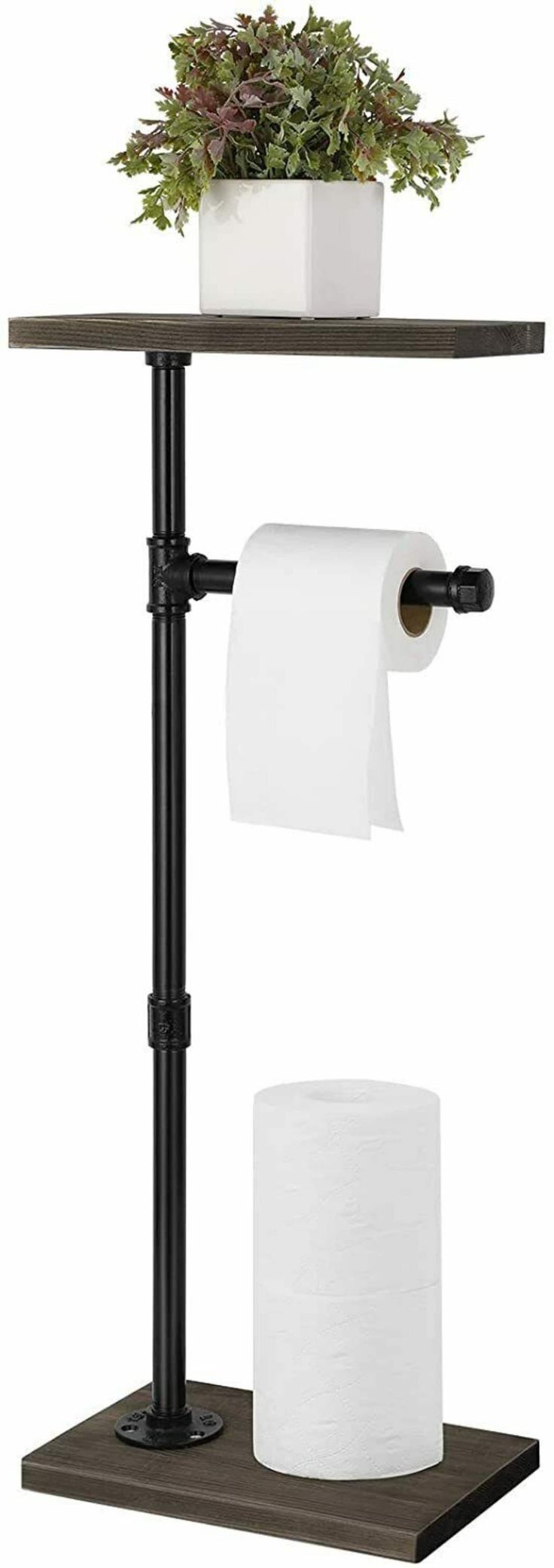 a toilet paper holder with two rolls of toilet paper on it and a potted plant