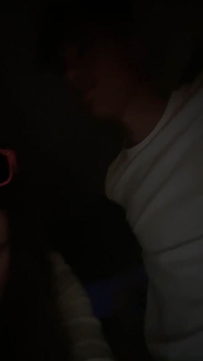 a person wearing red sunglasses in the dark