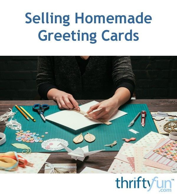 a woman is making cards on a table with scissors and other crafting supplies around her