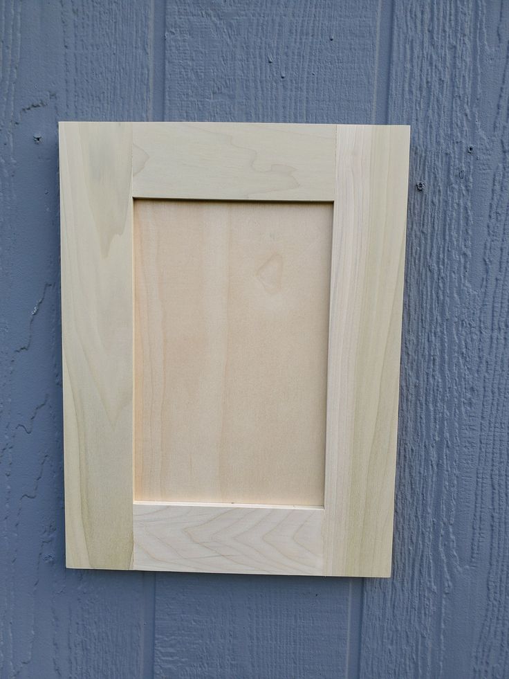 a wooden frame mounted to the side of a wall with a blue painted wood background