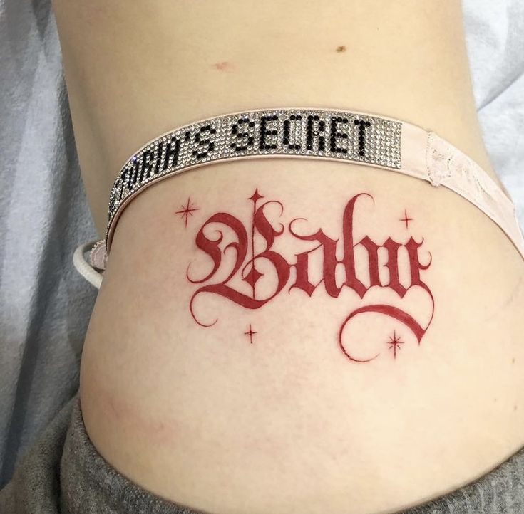 a woman's belly with the word birth tattooed on it