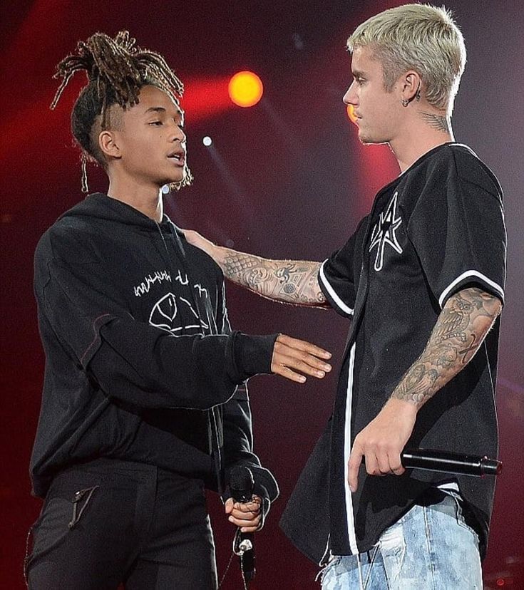 two young men standing next to each other on stage