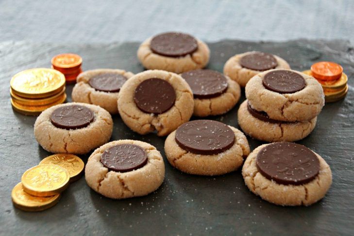 a pile of cookies sitting on top of a table next to coins