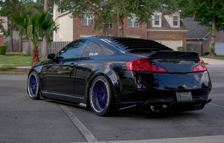 a black sports car parked in a parking lot