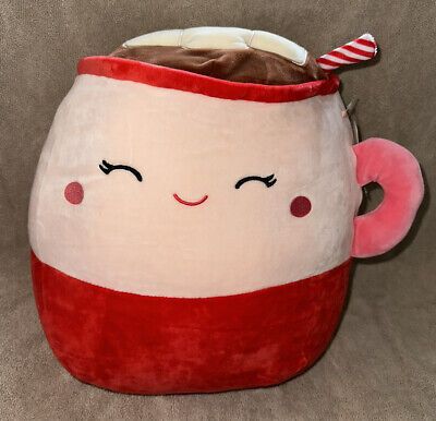 a red and white coffee cup shaped pillow