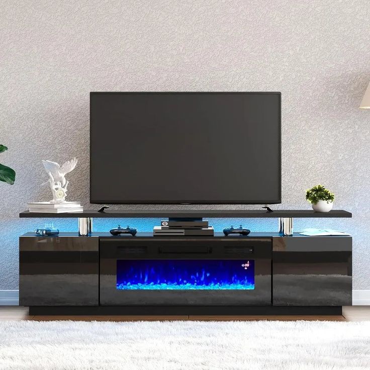 an entertainment center with a television and blue flames on the side, in front of a white rug