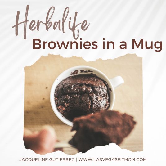 there is a brownie in a mug with chocolate on the side and words above it