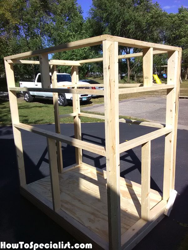 a wooden structure sitting in the middle of a parking lot