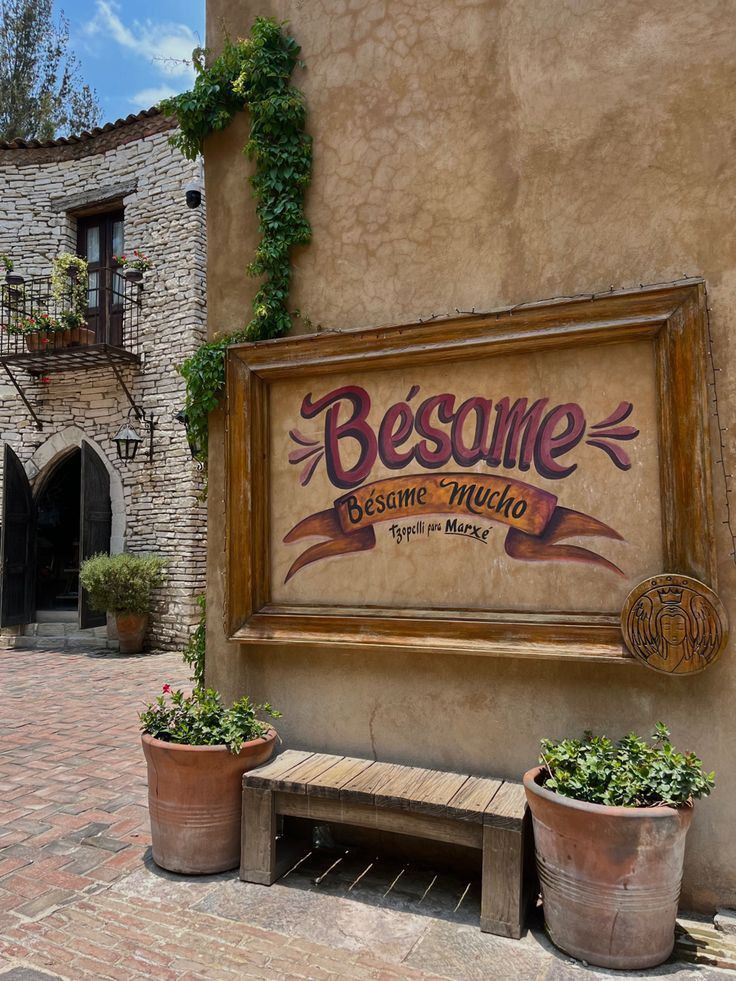 a sign on the side of a building that says besame restaurant in spanish