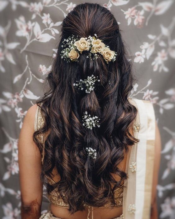 a woman with long hair and flowers in her hair