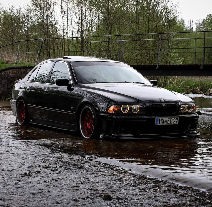 a black car is parked in the water