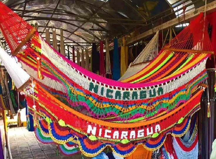 there is a colorful hammock hanging from the ceiling