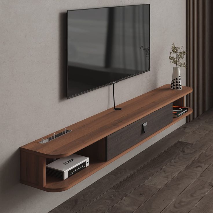 a flat screen tv mounted to the side of a wooden entertainment center in a living room