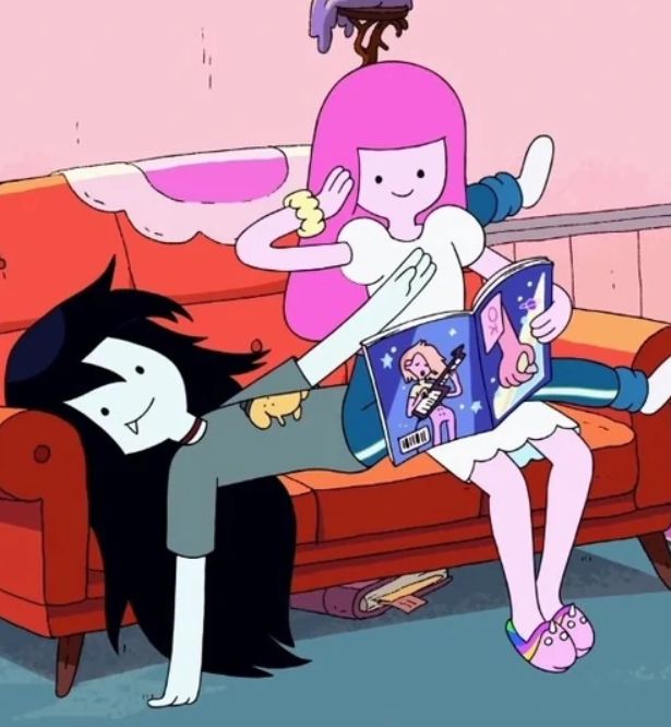 two cartoon characters sitting on a couch in front of a pink wall with an open book