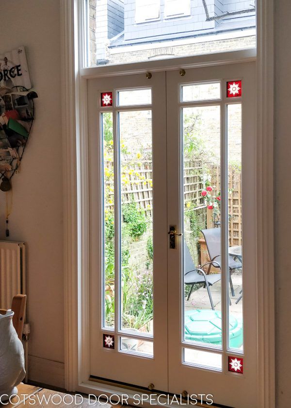 an open french door with glass panels on the outside and inside doors to another room