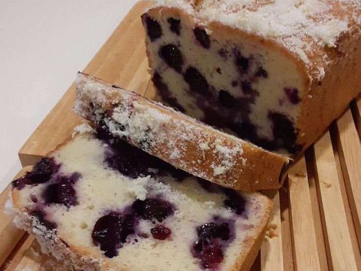 two slices of blueberry bread on a cutting board