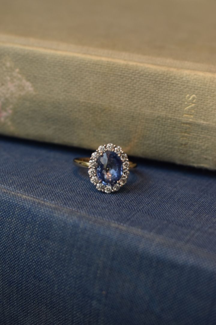 a blue ring sitting on top of a book