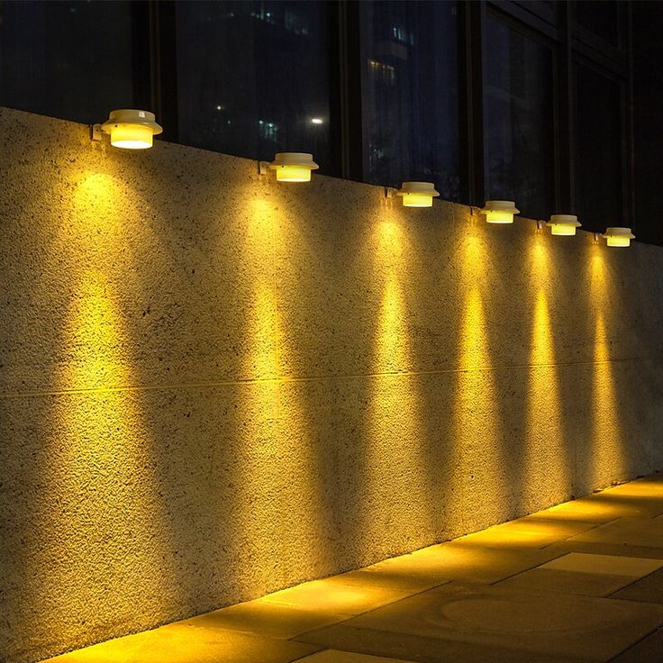 a row of lights that are on the side of a building