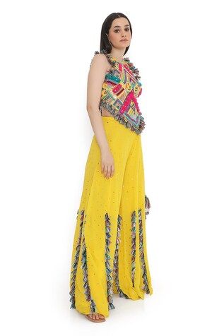 Yellow and multi color sleeveless back tie-up choli with all over bohemian tribe vibe embroidery and tassel embellishments. Paired with a mukaish dot embroidered sharara with tassel detailing. - Aza Fashions Bohemian Sleeveless Sharara For Navratri, Multicolor Fitted Sleeveless Sharara, Multicolor Georgette Palazzo Set For Summer, Multicolor Bohemian Georgette Sharara, Bohemian Sharara With Multicolor Embroidery, Multicolor Sleeveless Choli With Dupatta, Yellow Bohemian Palazzo Set With Dupatta, Bohemian Multicolor Embroidered Palazzo Set, Bohemian Embroidered Multicolor Palazzo Set