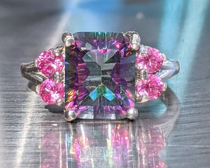 Gemstone has been tested on the most accurate machines for authenticity and accuracy All my gemstone jewelry comes in nicely wrapped, so they are ready to be given as gifts! Chose from either sterling silver or 14k gold silver takes 3-5 days to ship 14k takes about 8-10 days This Natural Mystic Topaz ring is so vibrant and Stunning. Top-quality rainbow topaz. It's hard to find this quality of rainbow topaz for this price. You won't be disappointed. This 3.5ct Mystic Topaz stud earrings are jaw-d Topaz Birthstone Gemstones For Gifts, Iridescent Birthstone Rings For Gift, Iridescent Ring Jewelry For Anniversary, Iridescent Ring For Anniversary, Iridescent Jewelry For Anniversary, Fine Jewelry Topaz Ring With Accent Stones For Gift, Fine Jewelry Topaz Ring Prong Setting Gift, Fine Jewelry Topaz Ring With Prong Setting Gift, Blue Topaz Gemstones For Gifts