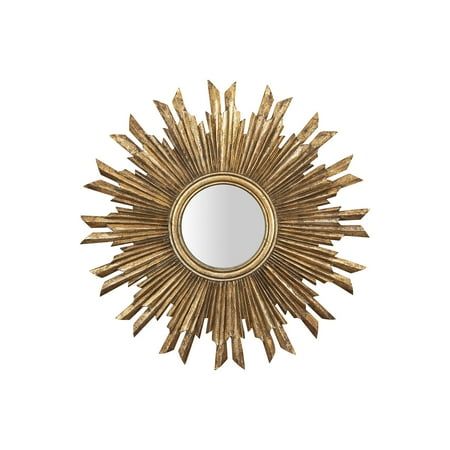 a mirror that is sitting on top of a white wall with a gold starburst design