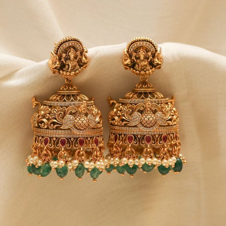 Show off India's culture and tradition by wearing perfectly handcrafted temple jewellery jhumkas! Explore our temple jewellery collection! Latest Design Earrings Gold, Gold Wedding Earrings Indian, Lakshmi Jhumkas Gold, Gold Antique Jhumkas, Lakshmi Buttalu Earrings Gold, Cz Earrings Indian Gold, Temple Jewellery Earrings Antique, Jumki Design Gold Latest, Temple Earrings Gold Jewelry