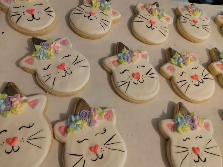 many decorated cookies with cats on them