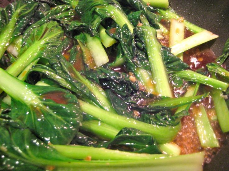 stir fried vegetables are being cooked in a wok