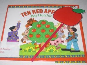 the children's book has an apple on it and is in front of them