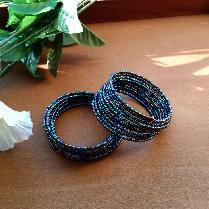 2pc Beautiful Kenyan Beaded Blue Coil Bracelet Set. Blue Bracelets With Tiny Beads For Parties, Party Multicolor Bracelets With Black Beads, Blue Beaded Bracelet With Black Beads For Festival, Stone Rings For Men, Wolf Pendant Necklace, Cartier Love Ring, Leather Cord Bracelets, Wolves Pendants, Pendant Necklace Simple