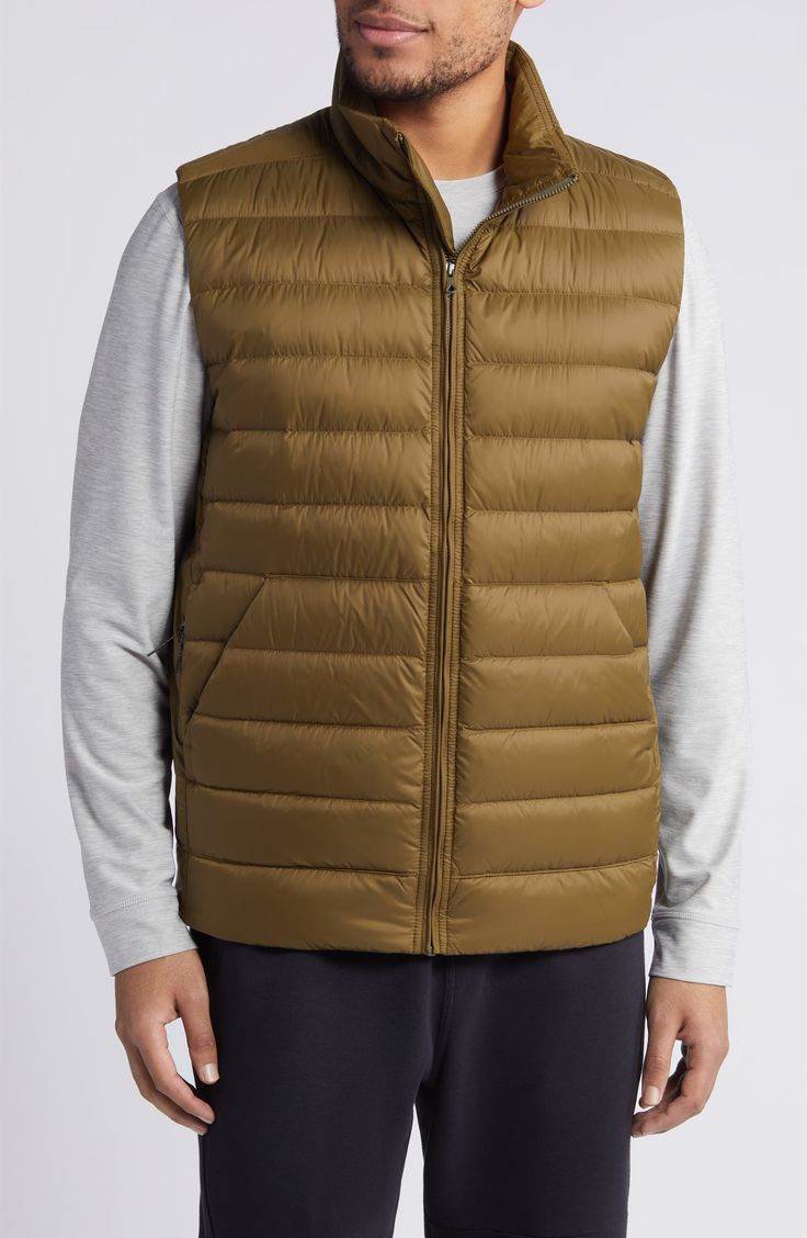 Whether you're deep in the backcountry or just your own backyard, you'll appreciate the cozy core warmth of this vest filled with 750-fill-power down. 26 1/2" length (size Medium) Front zip closure Stand collar Front zip pockets; interior chest zip pocket Durable water-repellent (DWR) finish Packs into pocket Lined, with 750-fill-power down 100% recycled polyamide Machine wash, tumble dry Imported Certified to the Responsible Down Standard (RDS) by Control Union Sleeveless Down Puffer Vest, Outdoor Down Puffer Vest, Outdoor Puffer Vest Made Of Down, Outdoor Puffer Vest With Down Filling, Outdoor Puffer Vest Jacket Sleeveless, Nylon Outdoor Vest With Pockets, Tactical Nylon Vest With Pockets, Brown Outdoor Vest With Pockets, Cozy Core