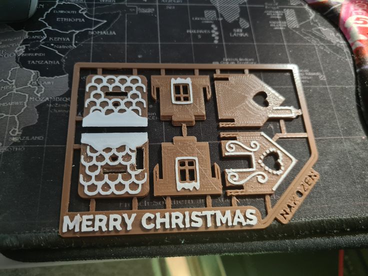 a close up of a christmas ornament on a table with a map in the background