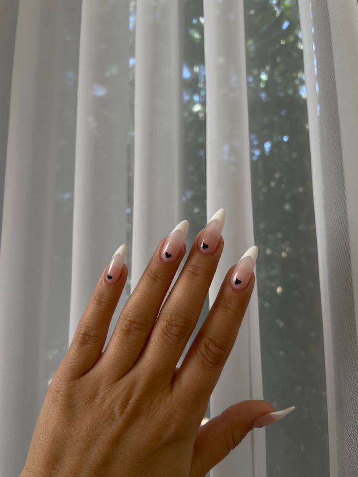 Black French Tip Heart Nails, White French Tip Black Heart, Black French Tip Nails Almond With Heart, Black French Tips With Hearts, Black French Tip Almonds, Almond Nails Heart Tips, Black French Tip Nails With Heart On Ring Finger, French Manicure With Black Heart, Black Almond Nails