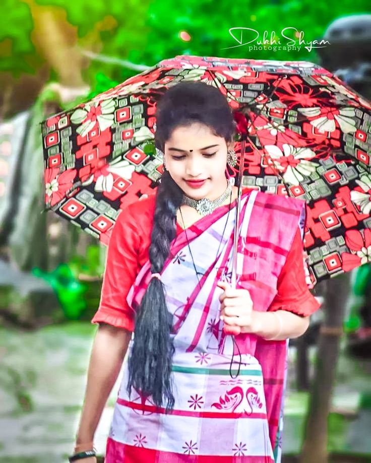 a woman holding an umbrella while walking down the street with her hand on her hip