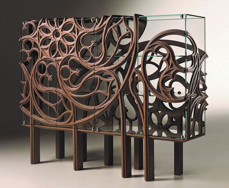 two pieces of art made out of wood and glass with intricate designs on the sides