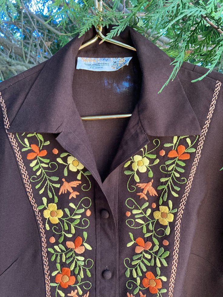 "This beautiful shirt jacket is from Helen Cerda of Guadalajara, Mexico.  It is a size 14 and is carefully hand embroidered in gorgeous bright colors!  The fabric is a cotton polyester blend for easy care.   This garment measures 41\" at the bust and at the hip (measured with the shirt buttoned).  The sleeves are 23\" long, and the shirt is 26.75\" long (measured from base of collar to hem at center back).   Free US Shipping!" Fitted Shirt With Multicolor Floral Embroidery, Long Sleeve Cotton Blouse With Machine Embroidery, Cotton Long Sleeve Blouse With Machine Embroidery, Cotton Blouse With Machine Embroidery And Long Sleeves, Fitted Cotton Shirt With Resham Embroidery, Fitted Cotton Outerwear With Resham Embroidery, Vintage Embroidered Fall Shirt, Fall Cotton Blouse With Floral Embroidery, Fitted Shirt With Floral Embroidery For Fall