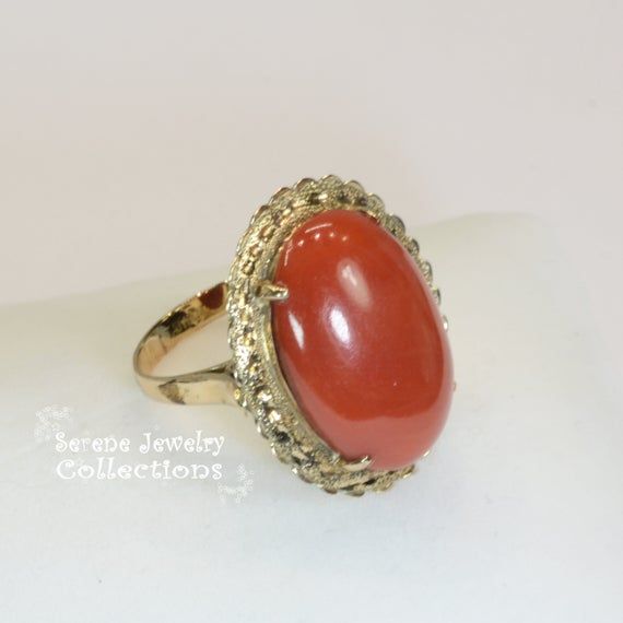 Vivid oxblood red Sardinia Coral Ring set in 14k yellow gold!Ring Size: 6.25Total Weight: 8.45 gramsPrecious Metal: 14k solid goldPrecious stones:-Coral Center Stone: 22.1mm x 15.5mm, 14.5caratsHallmark: 14k, TAIWAN Red Oval Cabochon Jewelry With Polished Finish, 14k Gold Red Cabochon Ring, Red Ruby Oval Cabochon Ring In 14k Gold, 14k Gold Cabochon Red Ring, Oval Cabochon Red Ruby Ring In 14k Gold, 14k Gold Rings With Red Cabochon, Red Oval Jewelry With Polished Finish, Formal 14k Gold Cabochon Rings, Heirloom 14k Gold Cabochon Jewelry