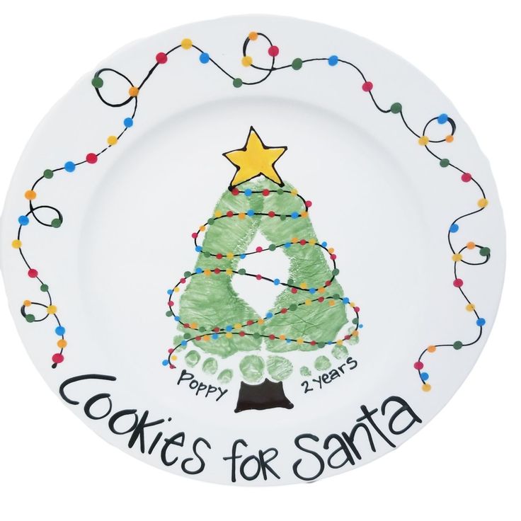 a white plate with a christmas tree painted on it and words written across the rim