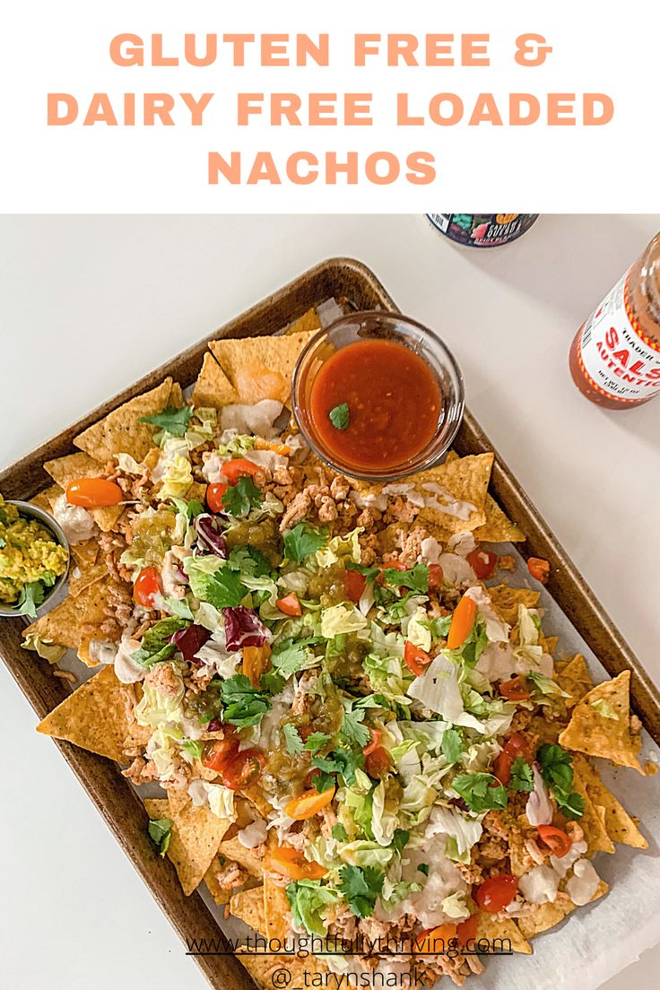 a tray filled with nachos, salsa and guacamole on top