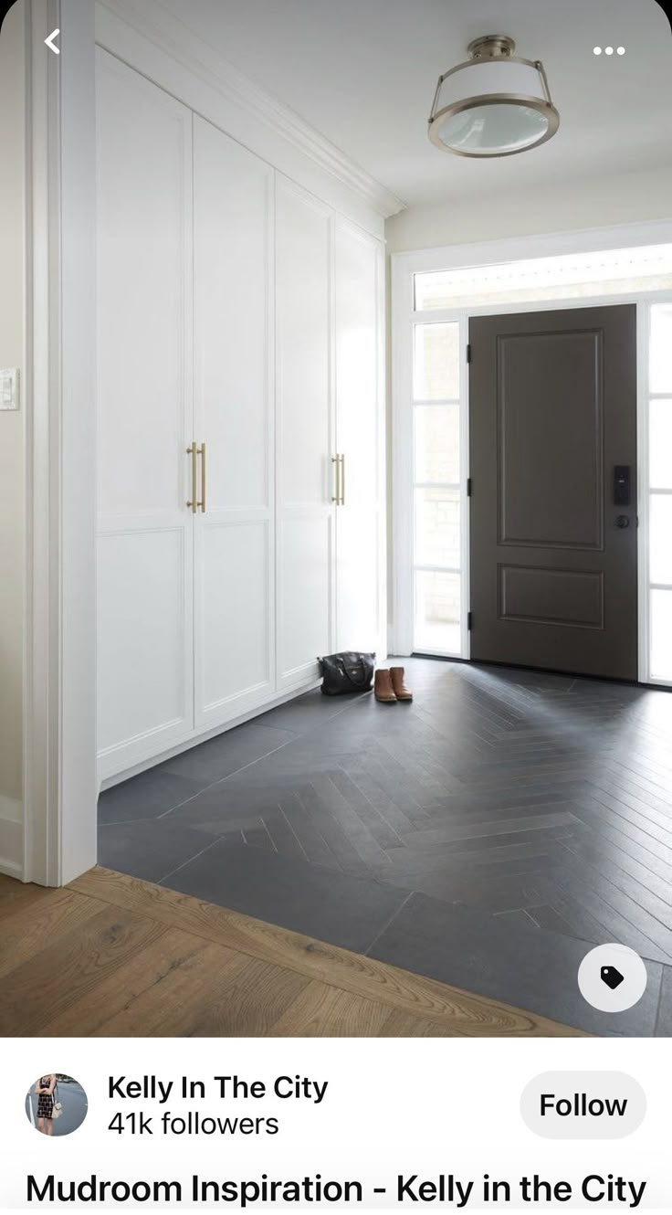 an empty room with white walls and wood flooring is pictured in this image, there are shoes on the floor next to the door