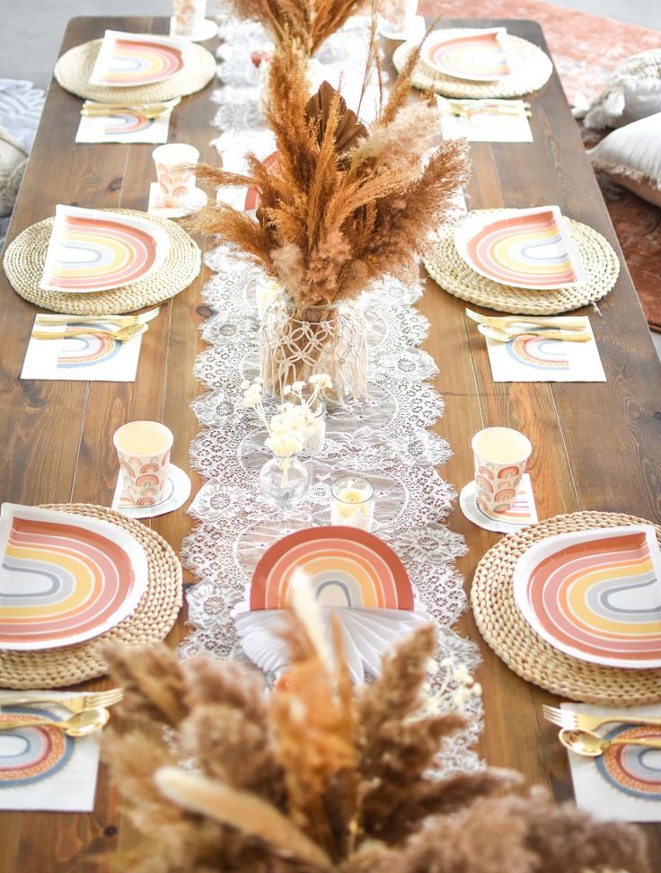 the table is set with plates and place settings