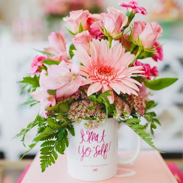 pink flowers are in a white mug with the words i want you self on it