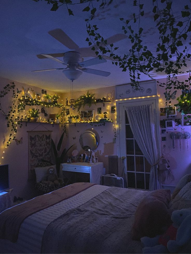 the bedroom is decorated with plants and fairy lights on the ceiling, along with other decorations